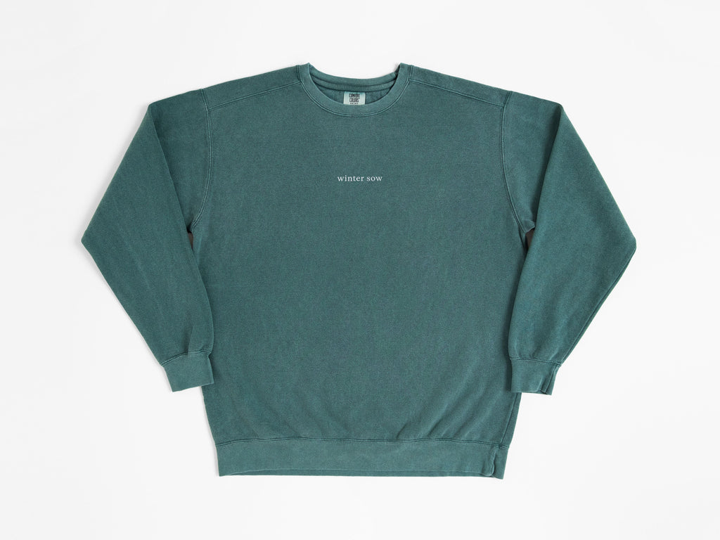 Green sweatshirt with white text on a white background