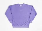 Purple sweatshirt with a small logo on a white background
