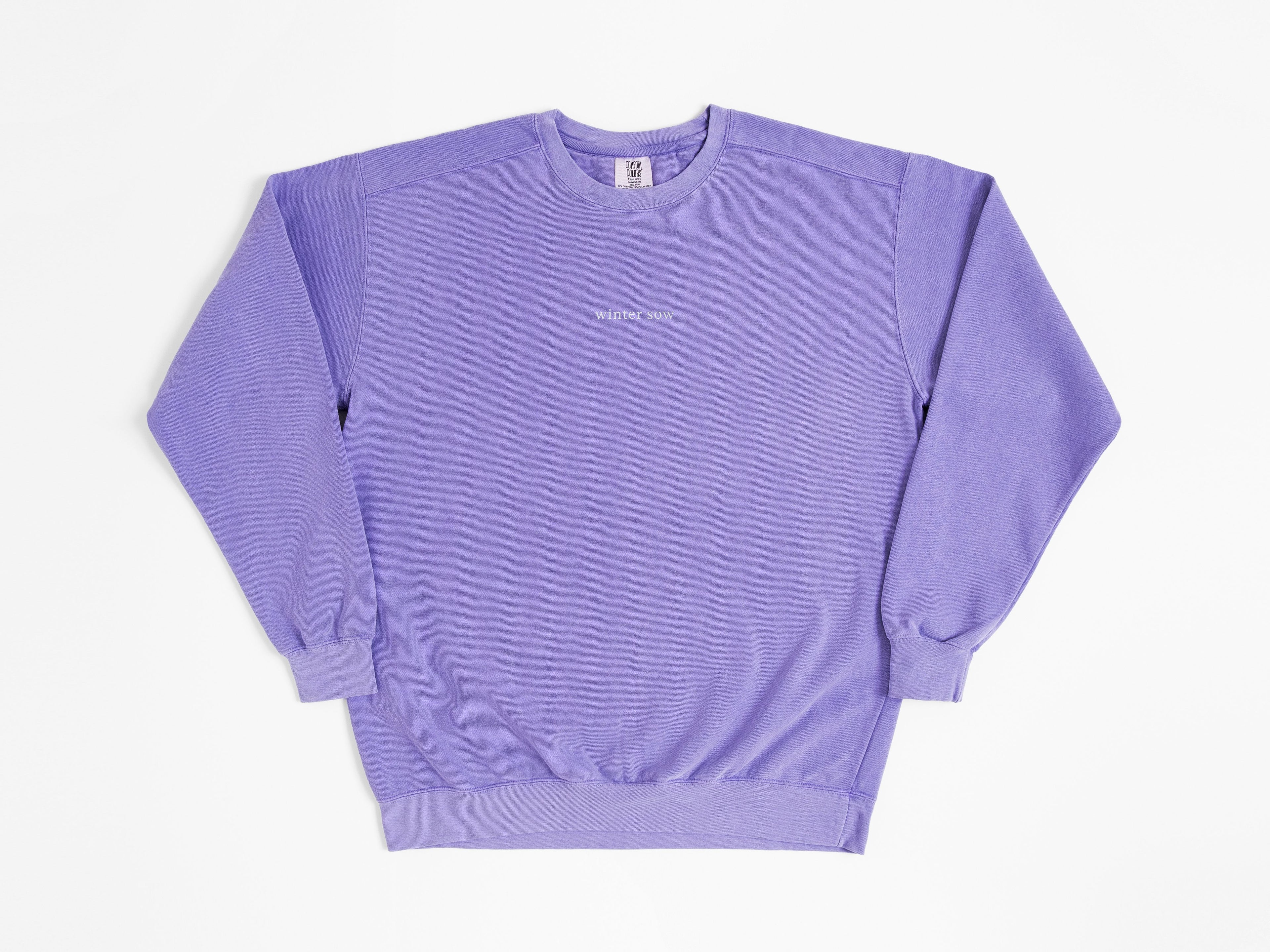 Purple sweatshirt with a small logo on a white background